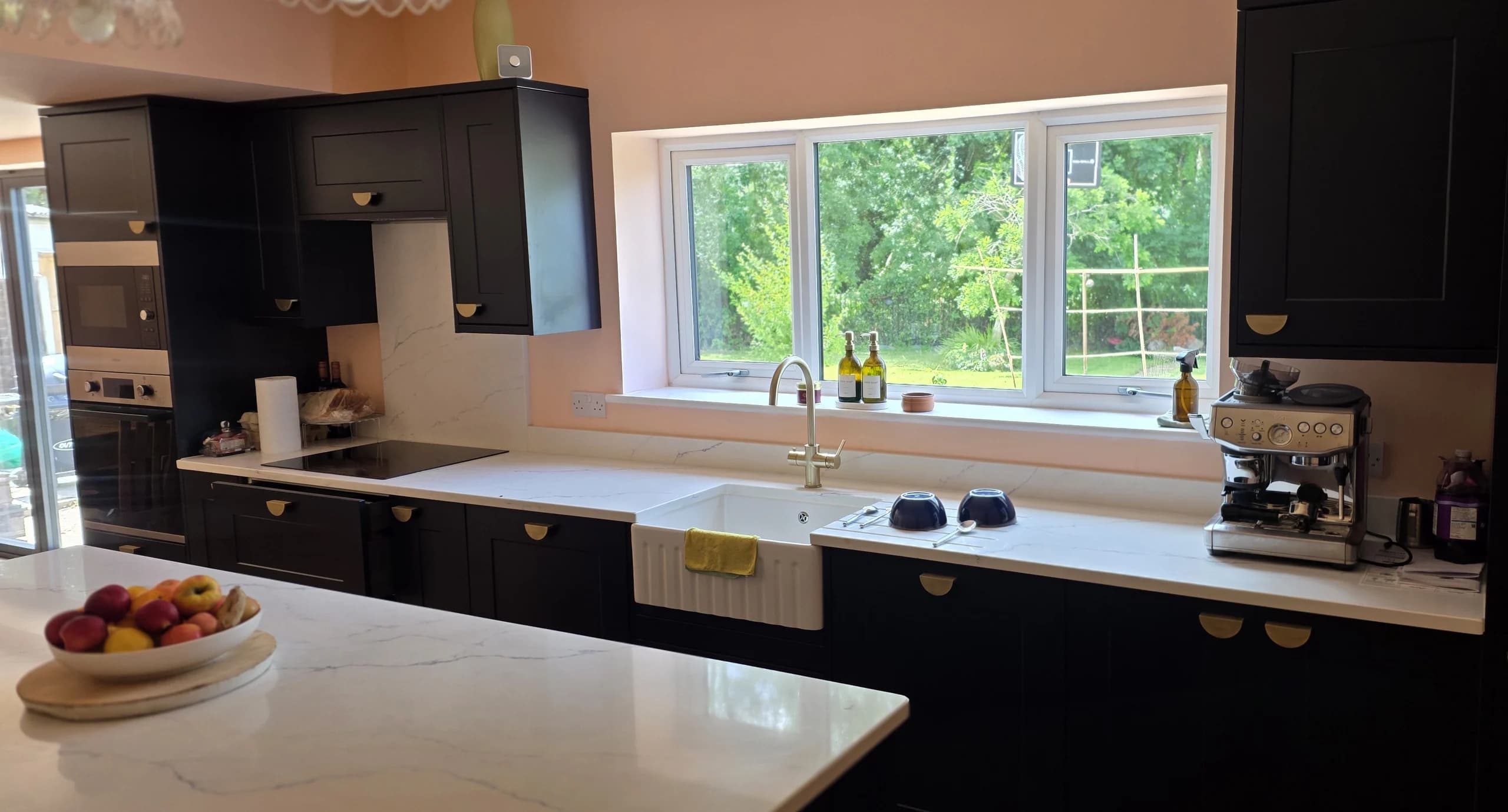 Completed Rushbrook Close kitchen extension with navy cabinetry, white worktops and a central island