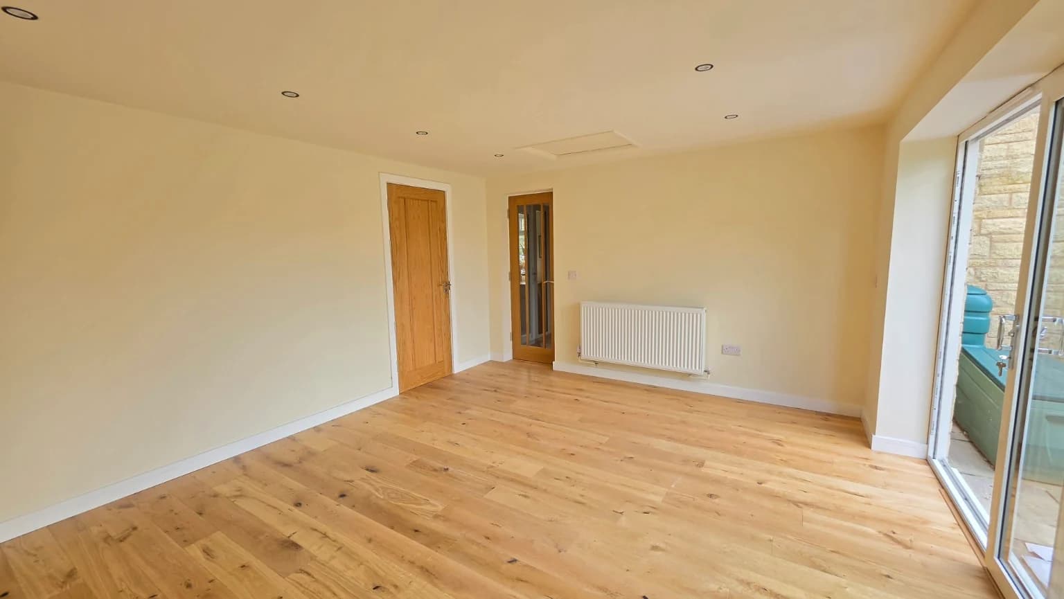 Second view of the completed reception room with internal joinery and a radiator