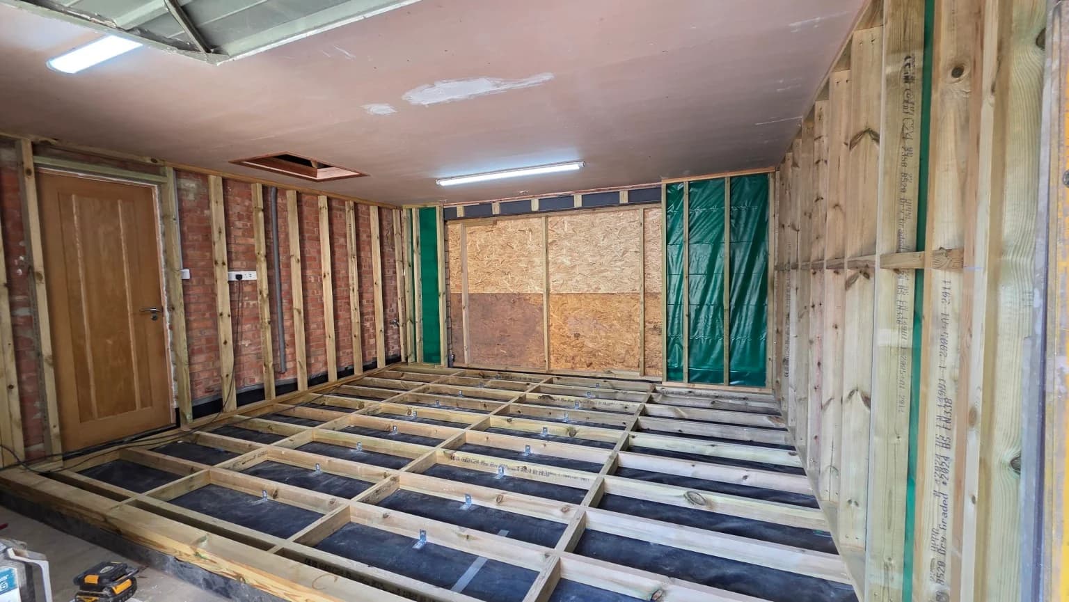 Timber floor construction and wall framing during the garage conversion