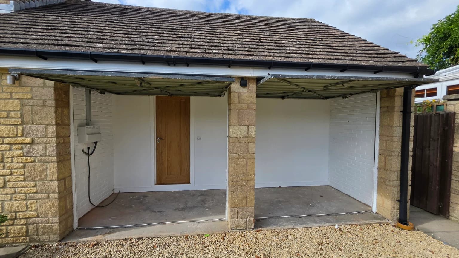 Retained space behind the original double garage doors, with the finished dividing wall and internal door
