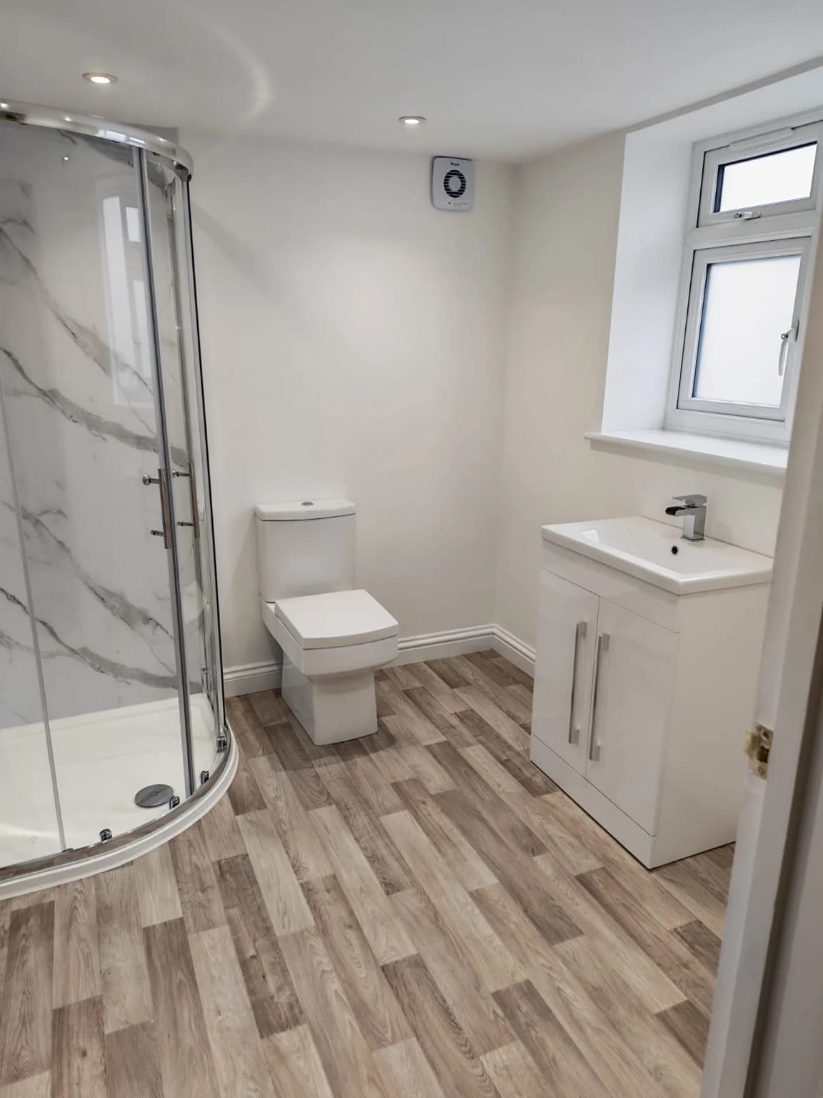 Completed garage conversion and shower room in Wellesbourne with a shower, WC and vanity
