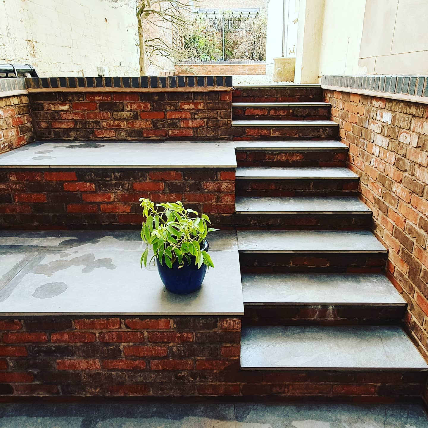 Completed porcelain-paved steps and reclaimed-brick retaining walls in Leamington Spa