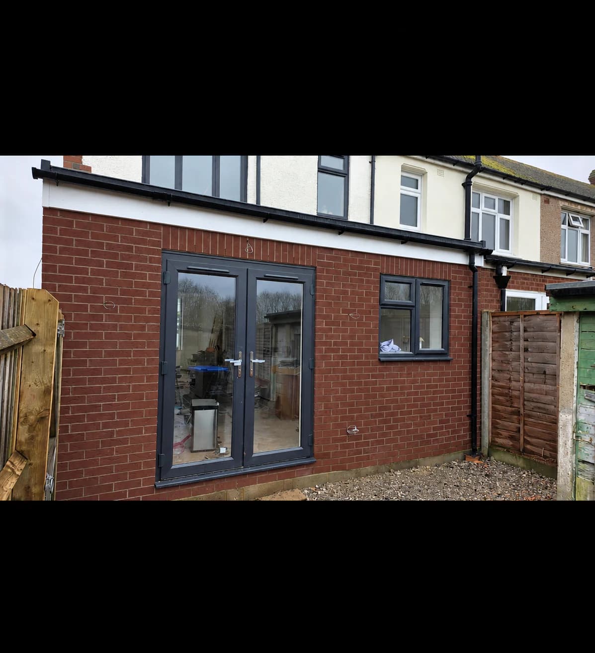 Brick rear extension with grey glazed doors and windows in Warwick